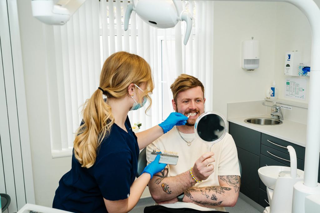 Dental patient testing veneer shades at Toftwood Dental Practice